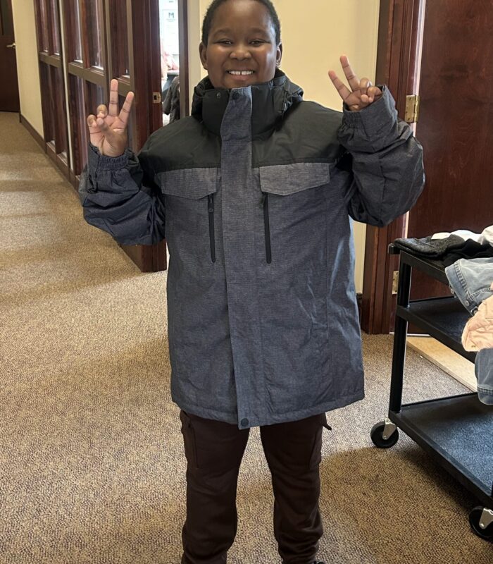 IMG_9283 image of child giving peace sign wearing a coat